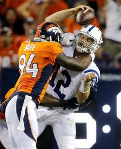 Indianapolis Colts quarterback Andrew Luck (12) is sacked by Denver Broncos defensive end DeMarcus Ware (94) during the first half of an NFL football game, Sunday, Sept. 7, 2014, in Denver. (AP Photo/Jack Dempsey)
