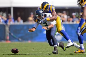 Sep 18, 2016; Los Angeles, CA, USA; Seattle Seahawks quarterback Russell Wilson (3) looses the ball as he is sacked by Los Angeles Rams defensive end Robert Quinn (94) during the first half of a NFL game against the Seattle Seahawks at Los Angeles Memorial Coliseum. Mandatory Credit: Kirby Lee-USA TODAY Sports