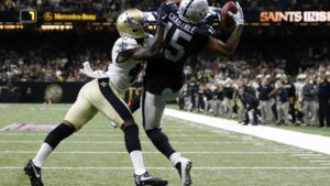 Michael Crabtree #15 of the Oakland Raiders catches a pass over Delvin Breaux #40 of the New Orleans Saints completing a two-point conversion to take the lead late in the second half of a game at Mercedes-Benz Superdome on September 11, 2016 in New Orleans, Louisiana.  (Photo by Jonathan Bachman/Getty Images)