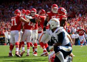 KANSAS CITY, MO - SEPTEMBER 11:  Quarterback Alex Smith #11 of the Kansas City Chiefs is congratulated by teammates after scoring a touchdown to win the game against the San Diego Chargers in overtime at Arrowhead Stadium on September 11, 2016 in Kansas City, Missouri.  (Photo by Jamie Squire/Getty Images)